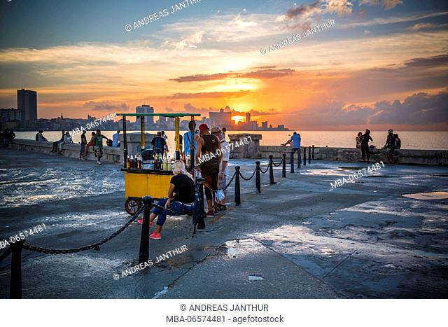 Malecon at sundown, the city in the background, evening mood, yellow booth