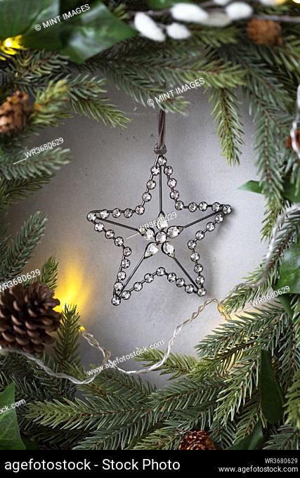 Christmas decorations, close up of silver star on Christmas wreath