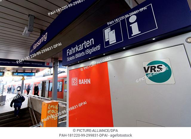 19 December 2018, North Rhine-Westphalia, Köln: A logo of the Verkehrsverbund Rhein-Sieg is stuck to a ticket vending machine at the Hansaring station