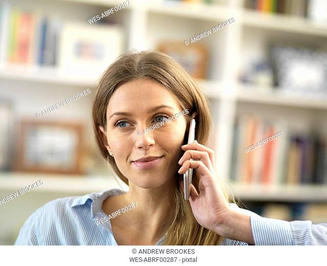 Young woman on cell phone at home