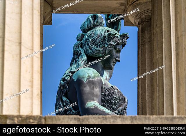 18 May 2022, Bavaria, Munich: The 18-meter-high Bavaria statue, which stands above the Oktoberfest grounds, can be seen against a blue sky between the stone...
