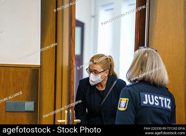 30 March 2022, Hessen, Darmstadt: Anja Darsow, wife of the defendant, looks into the courtroom before the decision of the Civil Chamber