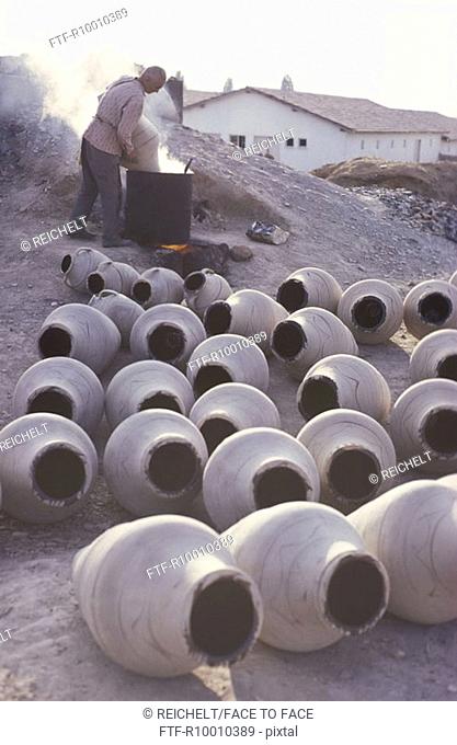 Worker producing clay vases, Turkey