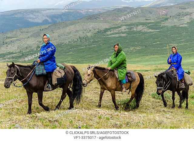 A group of Tsaatan ride their horses back to their camp, Tsaatan Camp, Hovsgol Province, Northern Mongolia