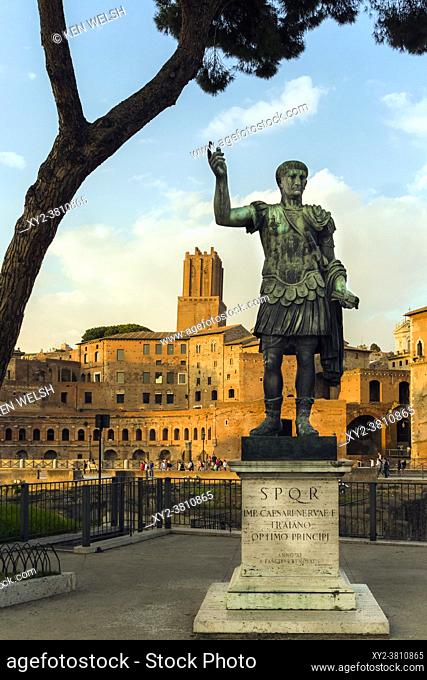 Rome, Italy. Statue of the Emperor Trajan with Trajan's Forum behind. The forum dates from the second century AD. The tower, centre
