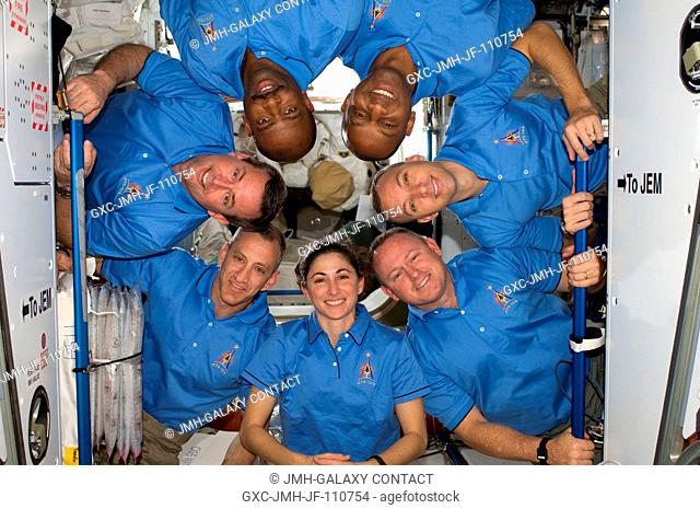 The STS-129 crew members pose for a portrait following a joint news conference with the Expedition 21 crew members (out of frame) from the Harmony node of the...