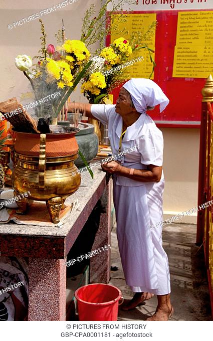 Thailand: An elderly woman helps clean incense sticks away during the height of the festivities, San Chao Chui Tui (Chinese Taoist temple)