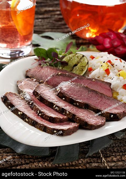 London broil beef with rice and a grilled lime