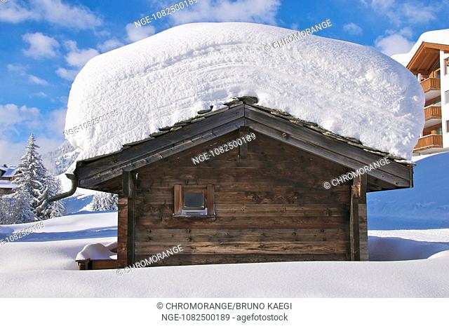 snowy chalet in Riederalp, Valais, blue sky