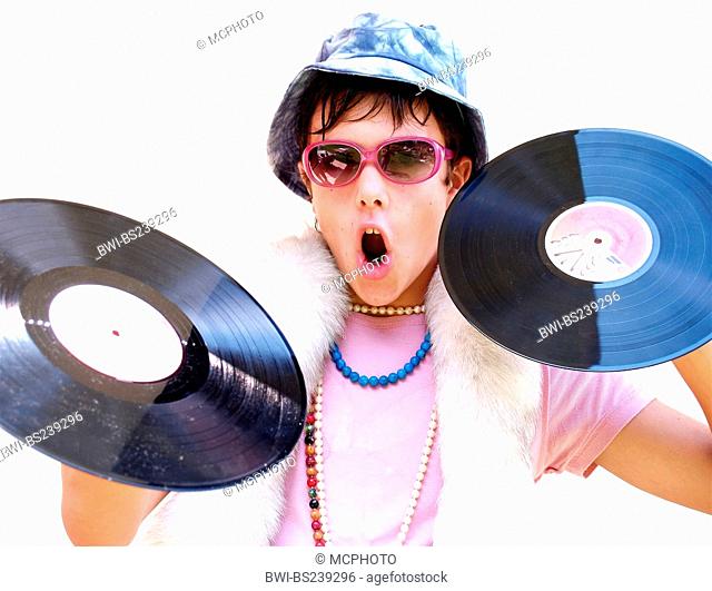 young disc jockey in a freaky outfit holding up vinyl discs