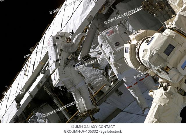 Astronauts Piers J. Sellers (left) and David A. Wolf, STS-112 mission specialists, work on the newly installed Starboard One (S1) Truss during the third and...