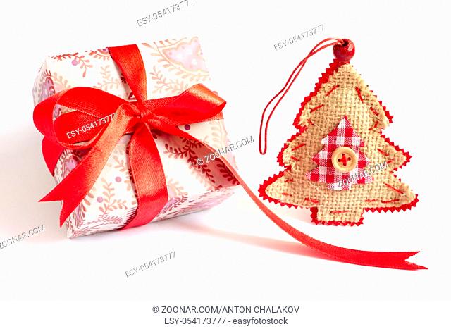 Christmas present and Christmas tree decoration stand on white background