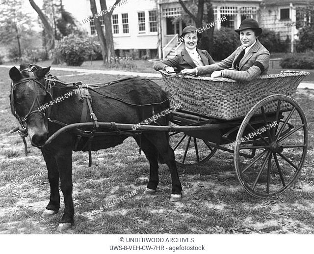 Washington, D.C.: May 2, 1935 Two Washington Junior League members grab a ride in a pony cart that will be part of the annual Horse Show