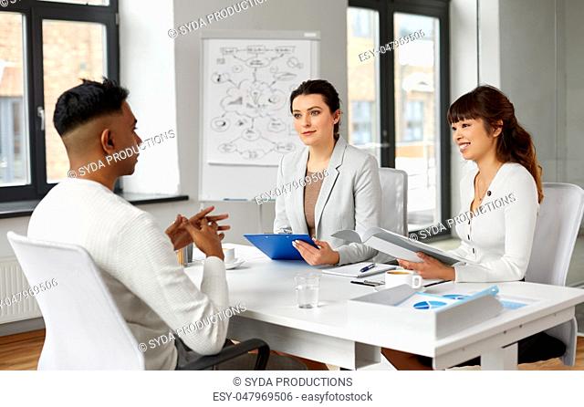 recruiters having job interview with male employee