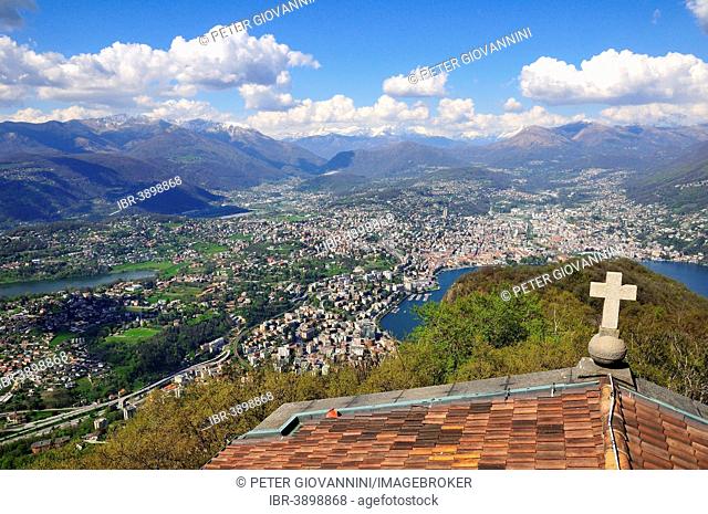 View over the roof of a chapel onto Lugano, Lake Lugano and the Alps, Monte San Salvatore mountain, Lugano, Canton of Ticino, Switzerland