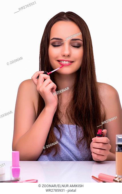 Woman doing makeup isolated on white