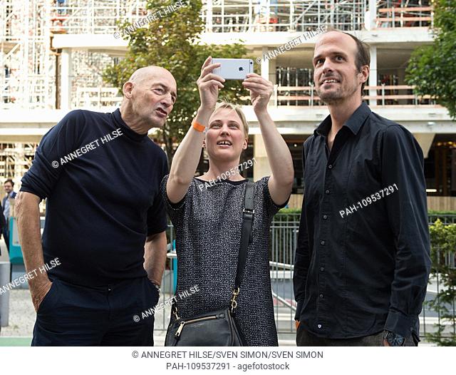 Architect Rem KOOLHAAS (l) stands by OMA architect Katrin BETSCHINGER, who takes a mobile phone photo of the Axel Springer SE headquarters