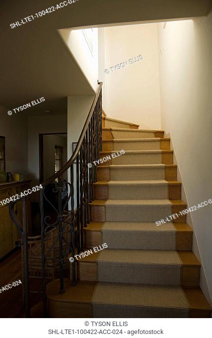 Staircase with carpet runner in home