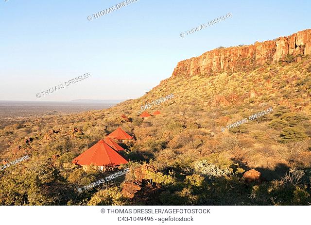 Namibia - The secluded chalets of the Waterberg Plateau Lodge just below the red sandstone rocks of the Waterberg Plateau  Waterbeg Plateau Park, Namibia