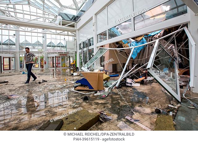 The promenade of a shopping mall is covered in wreckage and smashed pieces of glass in Erfurt, Germany, 18 May 2013. A severe thunderstorm with hail
