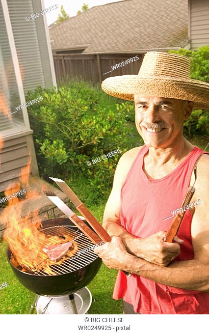 A man grilling in his backyard