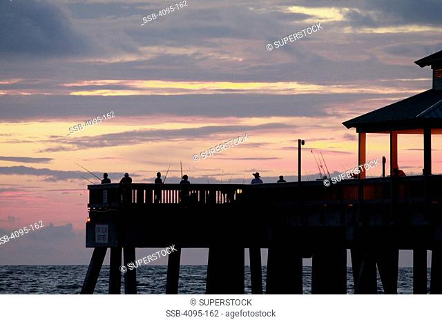 People fishing off the end of a pier at sunrise, Deerfield Beach, Broward County, Florida, USA