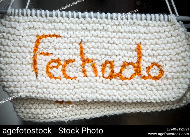 Closed sign in portuguese language. Crocheted crafts sign made