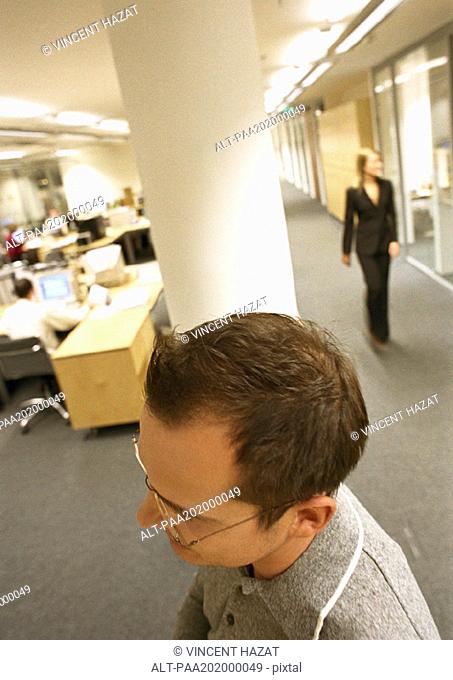 Businessman walking through office, view from above