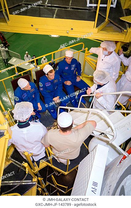 Expedition 49 crew members Andrey Borisenko of Roscosmos, left, Sergey Ryzhikov of Roscosmos, center, and Shane Kimbrough, right