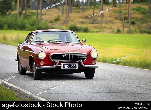 Classic red Volvo P1800 - widely known from the hit tv series The Saint - on vintage car rally. Produced 1961-1973. Salo, Finland. August 15, 2020