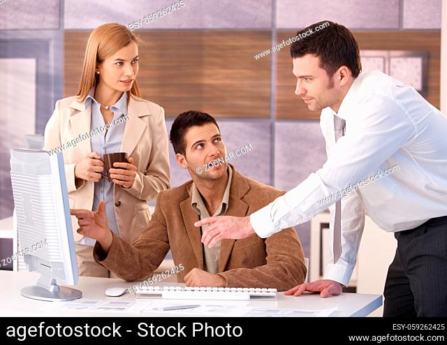 Young colleagues teamworking in office, having discussion