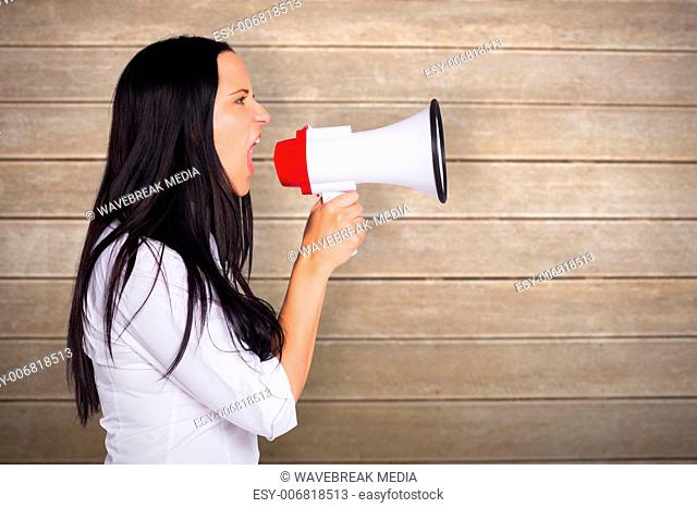 Composite image of young woman shouting through megaphone