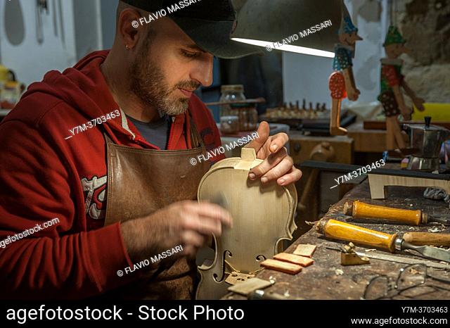 Neapolitan violin maker Alessandro Zanesco working in his atelier