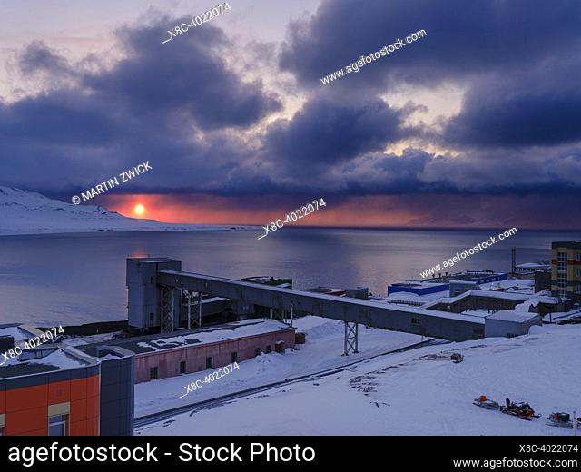 Sunset over the mine. Russian coal mining town Barentsburg at fjord Groenfjorden, Svalbard. The coal mine is still in operation