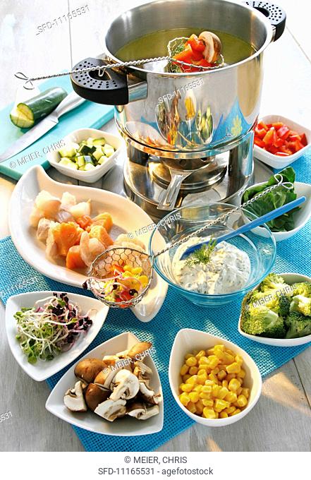 Fondue with fish and vegetables