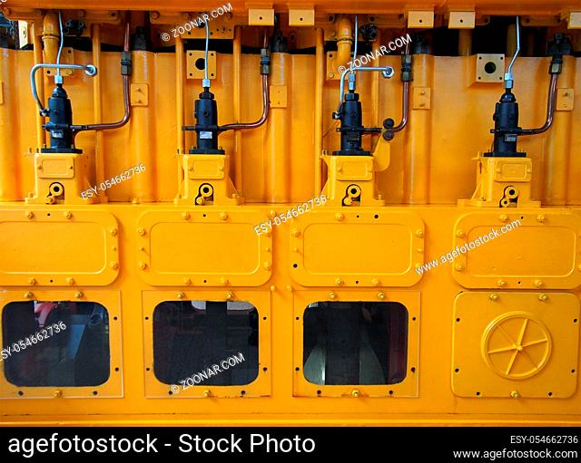 full frame image of a large yellow diesel engine used as an emergency standby electrical generator
