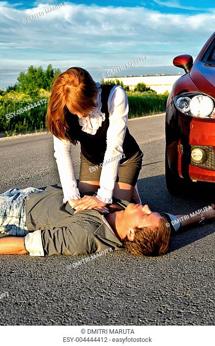 Young man reanimation on a road. Concept first aid