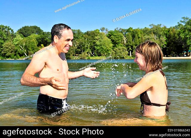 Family splashing in lake