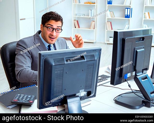 The businessman sitting in front of many screens