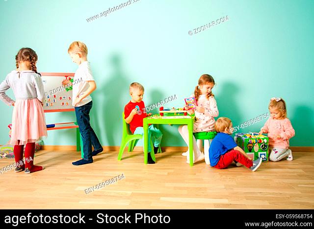 Different age kids at homeschooling. Educational and development toys for preschoolers and schoolchildren