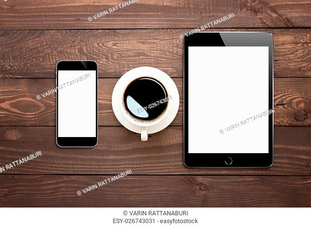 phone tablet and coffee cup on wood table top view