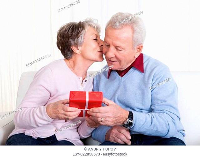Senior Man Giving Gift To Senior Woman