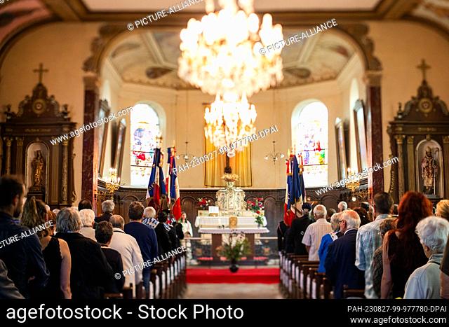 27 August 2023, France, Pexonne: People stand during a memorial service for the victims of the attack on Pexonne on August 27, 1944 in the village church