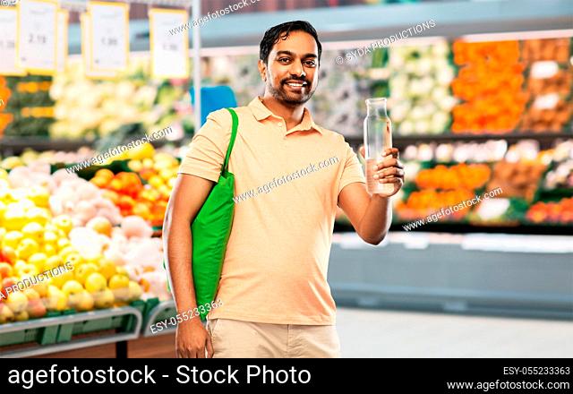 man with bag for food shopping and glass bottle