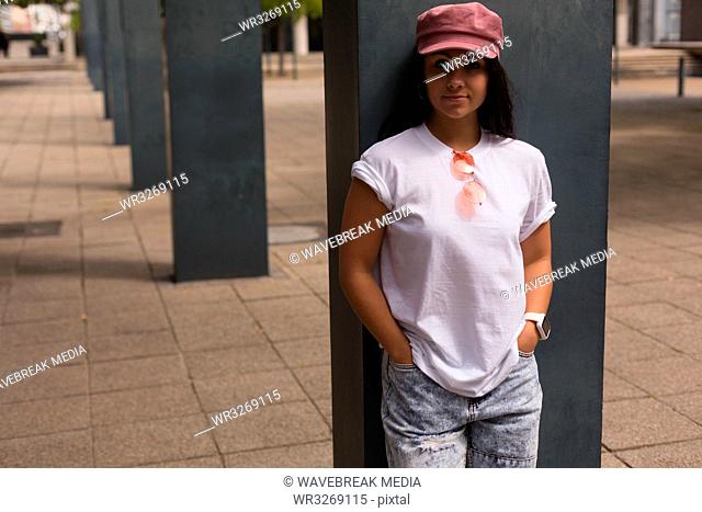Female skateboarder looking at camera in the city