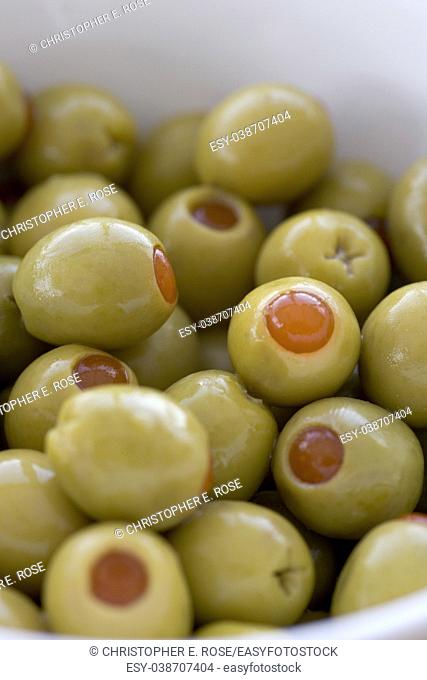 Pimento stuffed green olives in a white bowl