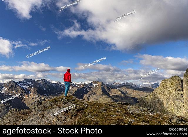Mountaineer on mountain path with Ötztal Alps and cloudy sky, Sölden, Ötztal, Tyrol, Austria, Europe