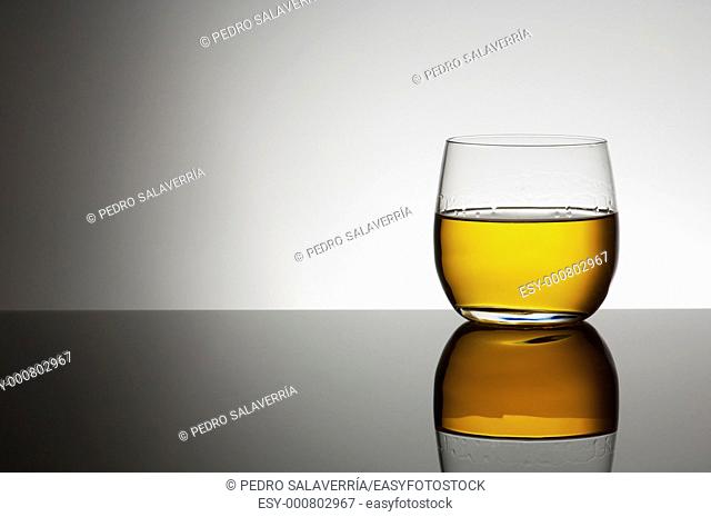 closeup of a glass of whiskey with a white background