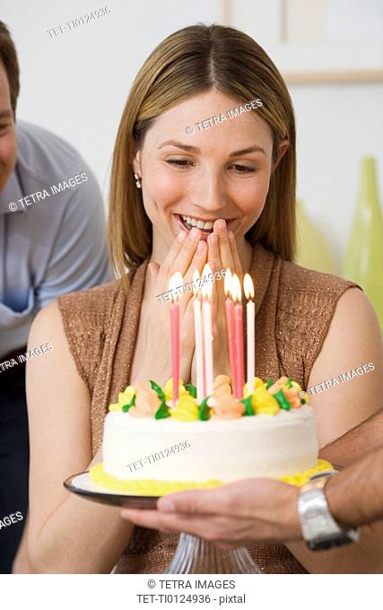 Woman smiling at birthday cake