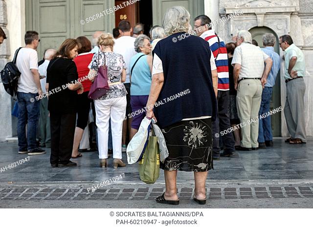 People enter a bank in Athens, Greece, 20 July 2015. Greek banks reopened on July 20 after a shutdown lasting three weeks but many restrictions on transactions